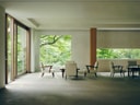 Lobby relaxation area at Beniya Mukayu with modern seating arranged around low tables and large garden-facing windows.