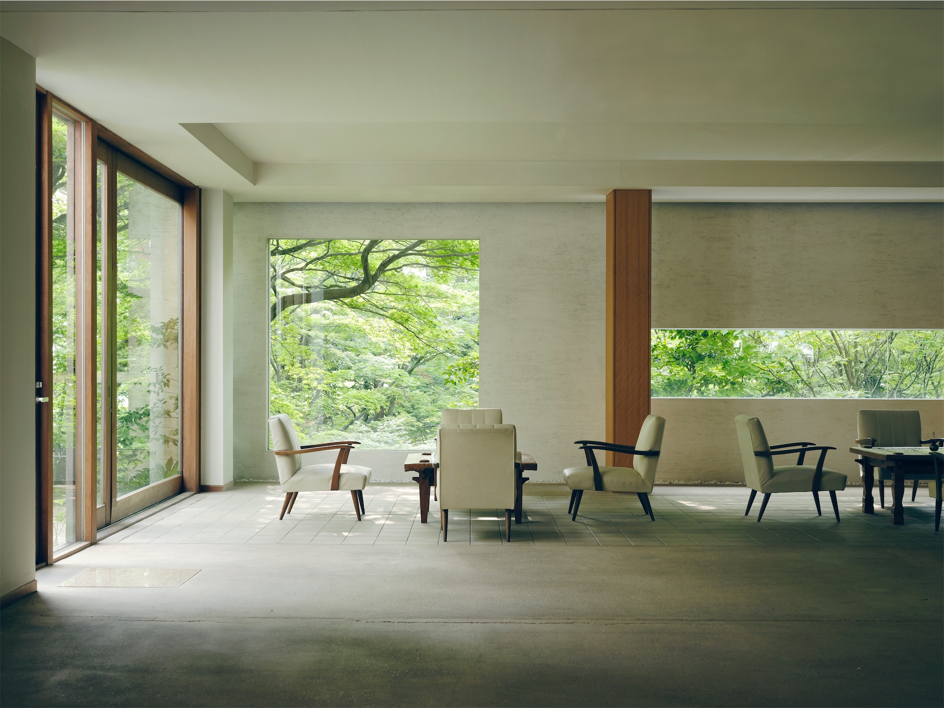 Lobby relaxation area at Beniya Mukayu with modern seating arranged around low tables and large garden-facing windows.