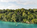 Lagoon view through dense foliage at Azul Nomeolvides.