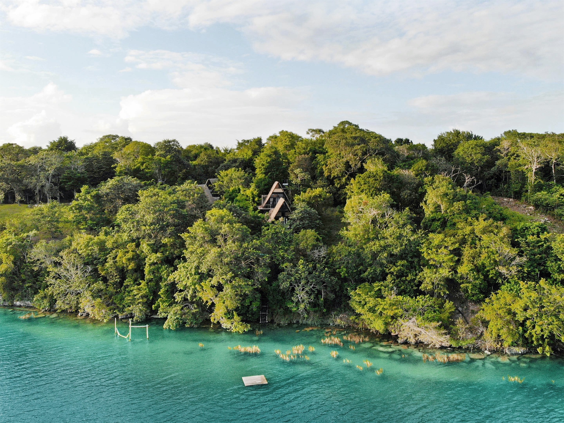 Lagoon view through dense foliage at Azul Nomeolvides.