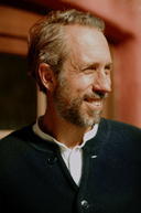 Portrait of Christian Mueller smiling indoors in warm natural light at Rosso House & Farm.