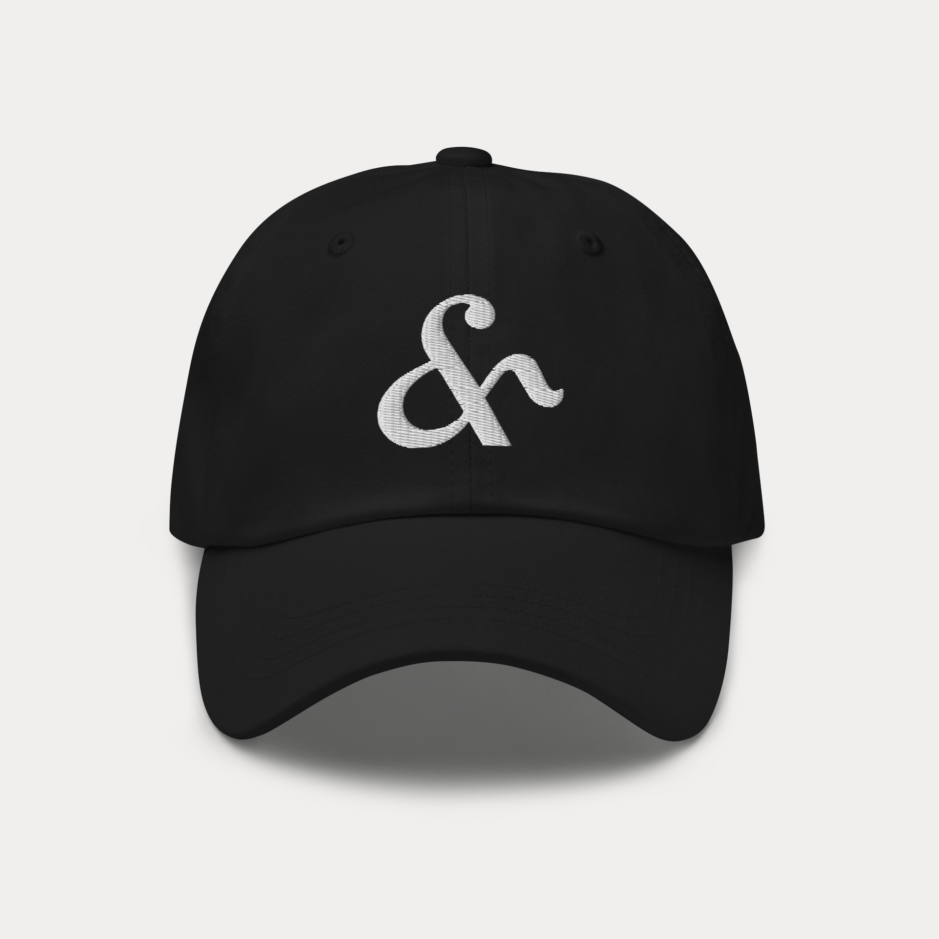 Black dad hat with Here & Away embroidered logo in cotton twill