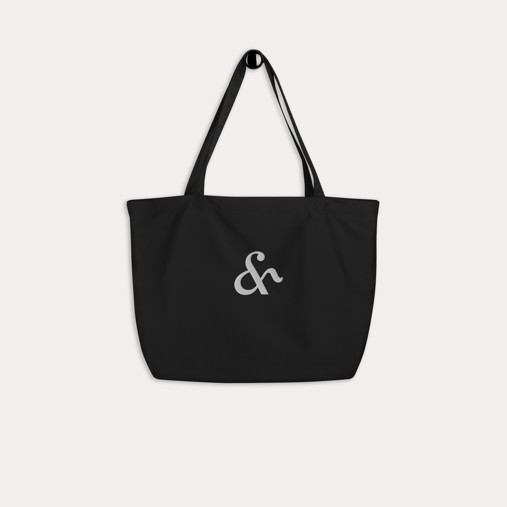 Organic cotton tote bag in black with Here & Away embroidered logo